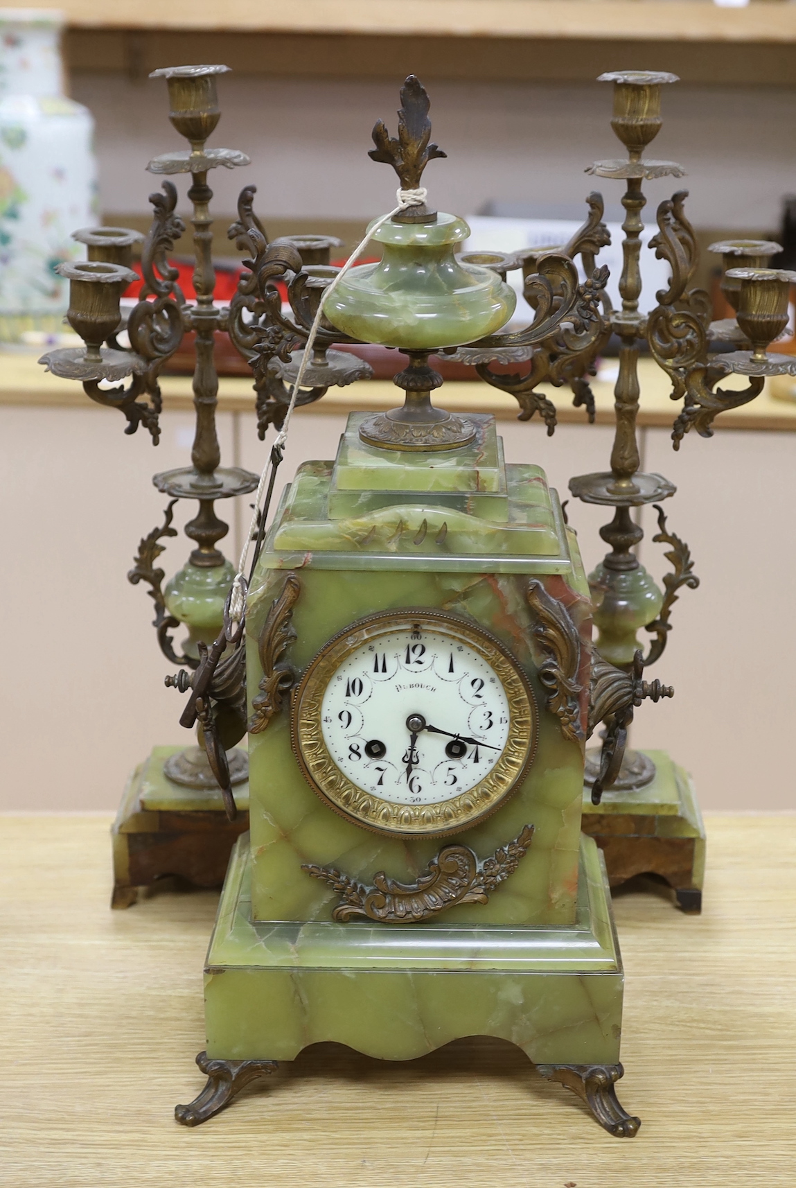 A French green onyx and bronze clock garniture, early 20th century, clock 50cm high